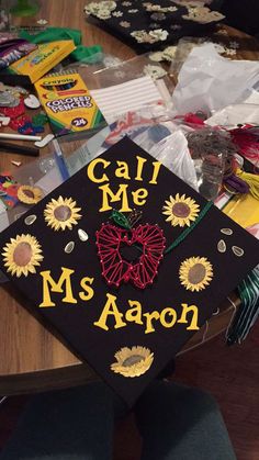 a graduation cap that says call me ms aaron on it sitting on top of a table