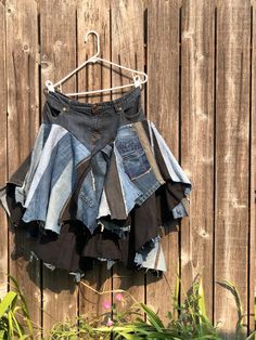 an old pair of jean shorts hanging on a wooden fence