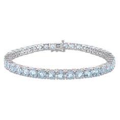 Get the perfect wedding accessory with this classy Tennis Bracelet. Crafted in sparkling sterling silver, this stunning bracelet showcases 35 round-cut, prong-set sky blue topaz gemstones (5x5mm). Enhanced with a high polished finish, this glamorous 7.25-inches bracelet is comfortably secured with a box clasp. Look classy and sophisticated at the upcoming high profile event with this premium jewelry. | Belk & Co 18.5 CT TGW Sky Blue Topaz Tennis Bracelet in Sterling Silver, White Daisy Gatsby, Topaz Bracelet, Silver Tennis Bracelet, Premium Jewelry, Blue Topaz Bracelet, Aquamarine Bracelet, Helzberg Diamonds, Sky Blue Topaz, Icy Blue