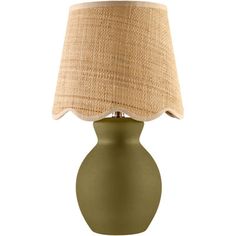 a green table lamp with a beige shade