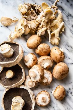 mushrooms are sitting on a marble counter top