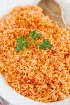 a white bowl filled with rice and garnished with parsley