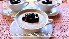 three cups filled with pudding sitting on top of a white saucer next to each other