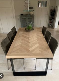 a wooden table with four chairs around it