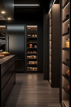 an empty kitchen with lots of shelves and lights on the ceiling, along with dark wood flooring