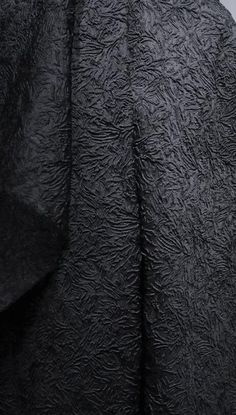 the back of a woman's black coat