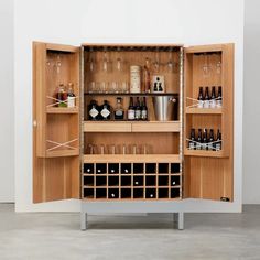 a wooden cabinet filled with lots of bottles and glasses