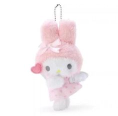 a hello kitty keychain hanging on a white wall with a pink bow around it's neck