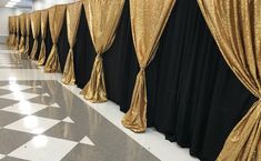 black and gold curtains are lined up against the wall