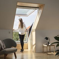 a woman standing in front of an open window