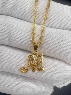 * 22K Gold Filled Wave Chain, Necklace With Sparkling Cubic Zircon Crystals Alphabet Letter M * Chain Width 2mm * Chain Length 45cms This Pendant has a thick layer of gold plating, that does not discolour or oxidize. It is hypoallergenic, which means that it does not react with human skin. IT IS ABSOLUTELY STUNNING. THE NECKLACE WILL BE PRESENTED IN A GIFT BOX Is This Piece Made Of Solid Gold? No.  The item is Gold Filled , used to describe a specific form of gold plating, does not, as the term Star Bangle, M Necklace, Wave Necklace, Gold Bond, Solid Gold Jewelry, Gorgeous Necklaces, Gold Filled Jewelry, Quality Jewelry, Gold Chains