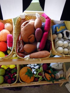 three baskets filled with stuffed animals sitting on top of a table