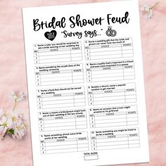 the bridal shower food survey sheet is next to some flowers on a pink surface