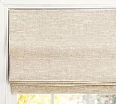 a beige roman blind in front of a window