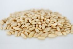 a pile of sunflower seeds on a white background