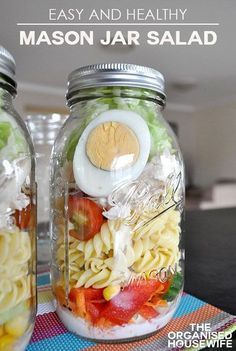 two mason jars filled with pasta and vegetables