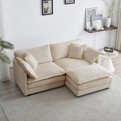 a living room with a sectional couch and white rug