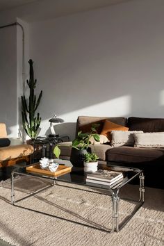 a living room filled with furniture and a large mirror on the wall above it's coffee table