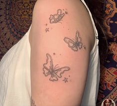 a woman's shoulder with three butterflies on it