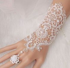 a woman's hand with white lace on it