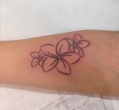 a woman's arm with a flower tattoo on it