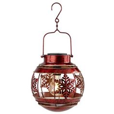 a red lantern with snowflakes hanging from it's side on a white background