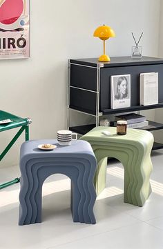 three stools sitting in front of a table with pictures on it