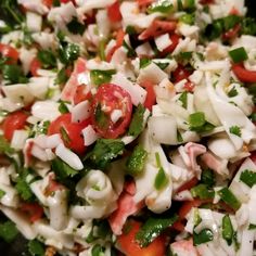 a salad is shown with tomatoes, onions and green peppers on it's side