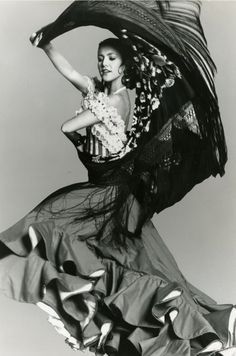 a woman in a long dress is dancing