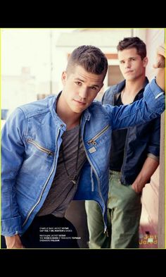 two young men are posing for a photo together, one is wearing a denim jacket and the other has a black shirt