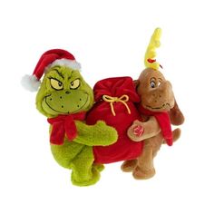 two stuffed animals wearing santa hats and holding onto each other