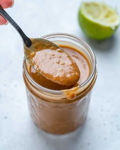 a spoon full of peanut butter with the words how to make thai peanut dressing on it