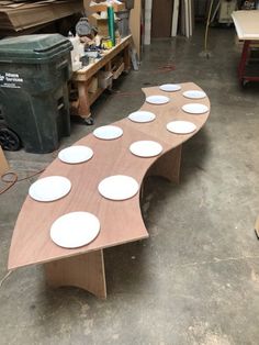 a bench made out of plywood with white plates on it