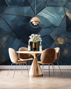 a dining room table with chairs and vases on it in front of a blue wall