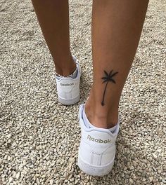 a person with a small palm tree tattoo on their foot