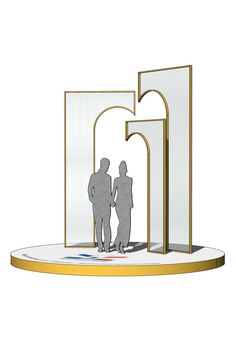 two people standing next to each other in front of an arch with the letter g on it