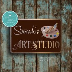 a sign that says sandi's art studio with an artist's palette on it