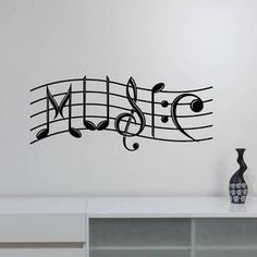 a wall decal with musical notes and the word music written in black on it