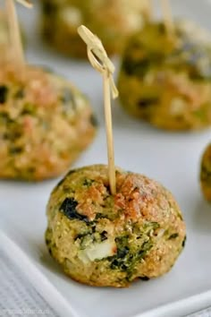 broccoli and cheese appetizers with toothpicks on a white plate