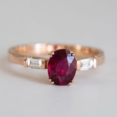 an oval ruby and baguette diamond ring