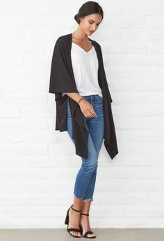 This versatile piece goes from cardigan to wrap to scarf! Ideal for travel and layering in soft, sustainable modal. Shop Now! Oversized Black Cape For Layering, Black One Size Kimono, Black Wrap Cardigan For Fall, Black Shawl Wrap For Fall, Black Shawl For Fall, Versatile Black Open Front Cardigan, Black Scarf For Fall, Black Wrap Cardigan For Layering, Oversized Wrap Shawl