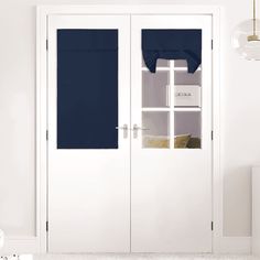 a white room with two doors and blue curtains