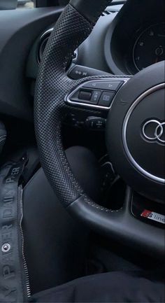 the inside of a car with steering wheel and dashboard