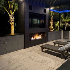 an outdoor fireplace and lounge chairs in a room