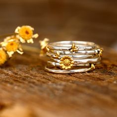 A set of six stackable rings with cute tiny bees and sunflower. Unique nature ring. Made of sterling silver and gold plated brass. ❥ Metal: Solid sterling silver and gold plated brass bee and sunflower (only the golden part) ❥ US Ring Size: Choose Size ❥ Ring Width: 15mm This is a wide ring. We recommend choosing a half or a full size up than your regular size for the best fit. ✈ Free Shipping (USPS) 🎁 Free Gift Box ↻ 60 Days Return ⌛ 24 Handling Time ** GET 15% OFF COUPON ** Visit 👉 boho-magi Apatite Ring, Star And Moon Necklace, Raw Gemstone Ring, Sunflower Ring, Sunflower Jewelry, Raw Stone Ring, Retro Ring, Stacking Ring Set, Layered Necklace Set