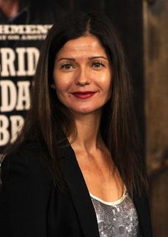 a woman standing in front of a poster