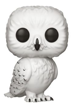 a white owl figurine with black eyes