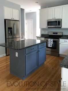 a kitchen with an island and stainless steel appliances