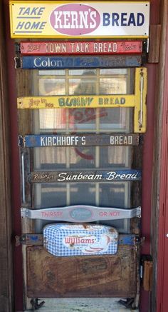 an old door with many signs on the front and side of it, including bread