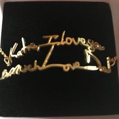 a gold bracelet with the word i love you in cursive writing on it